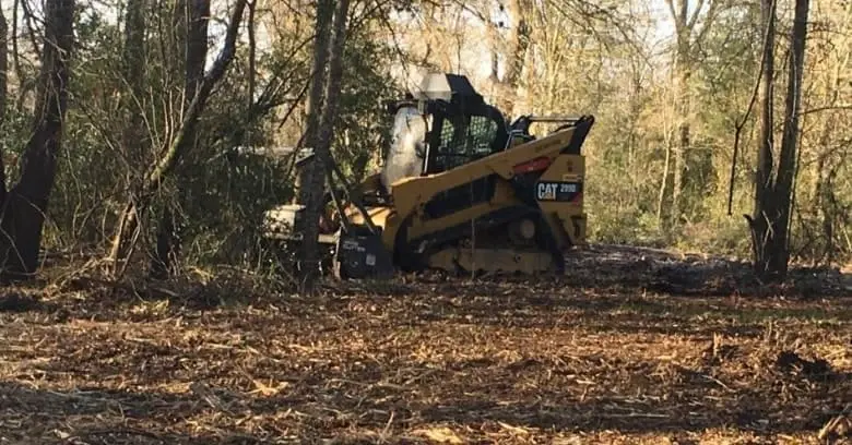 Excavator site grading and subgrade preparation