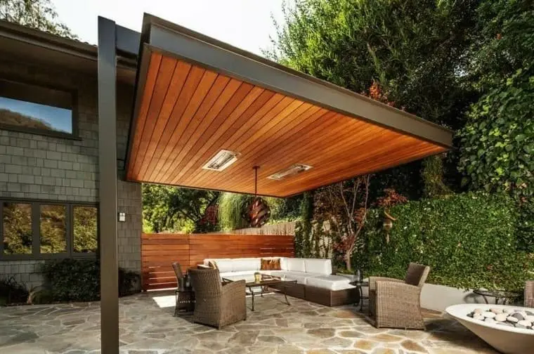 Handcrafted cedar shade pergola over stone paver patio